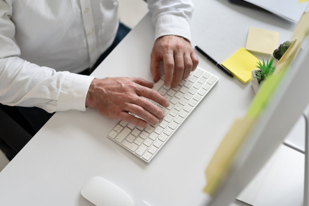 Businessman Typing on Keyboard in Modern Office Workspace